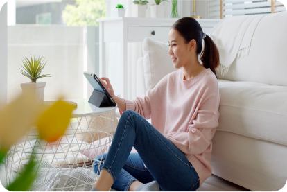 woman sitting on the floor looking at a tablet
